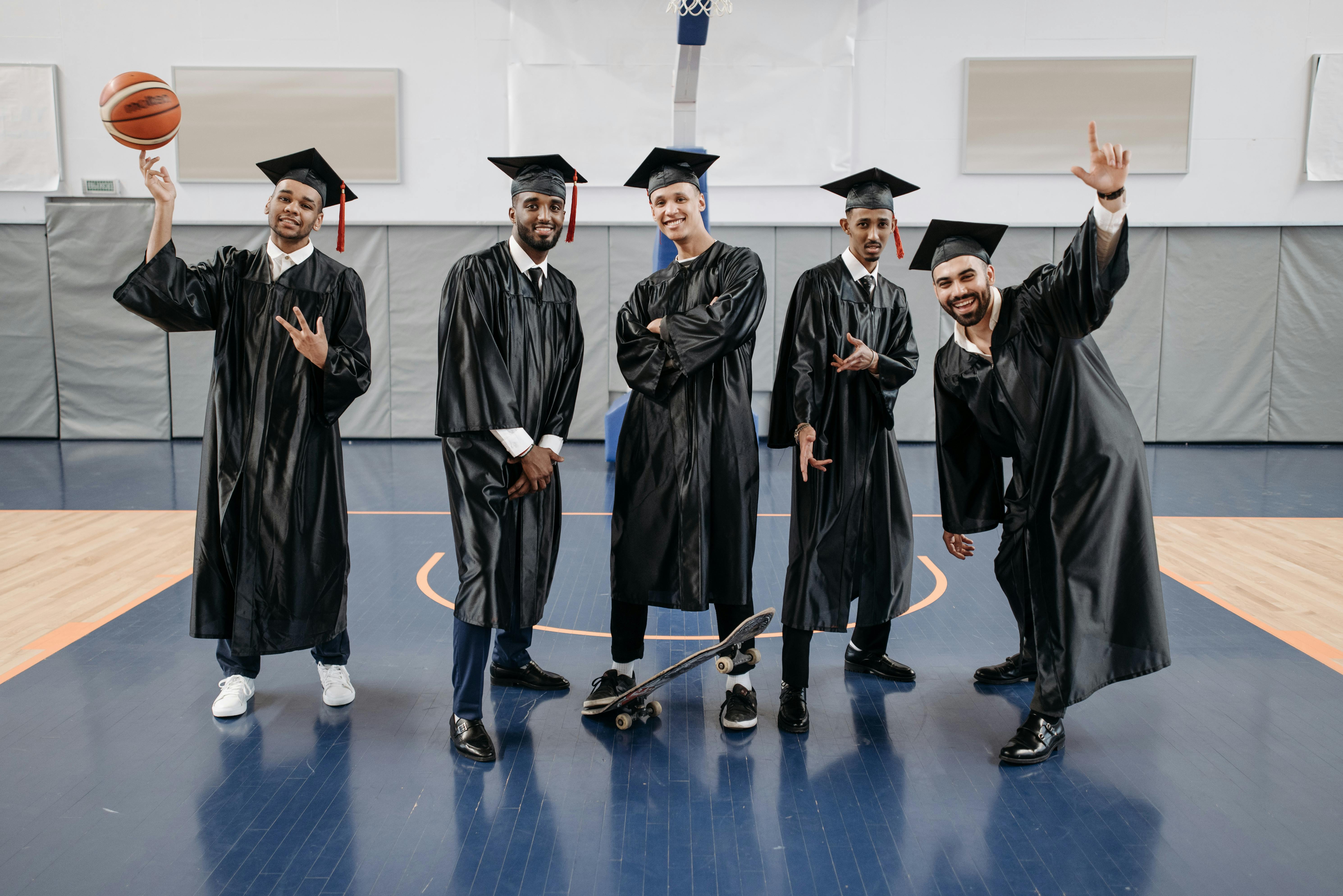 Graduates celebrating in gym with basketball